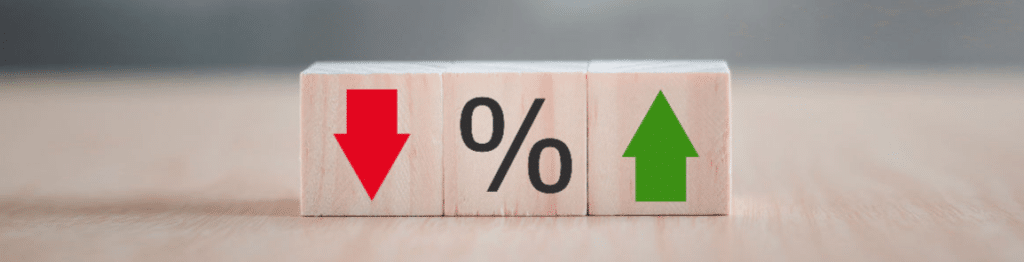 3 Wooden Blocks - Red Down Pointing Arrow, Percentage Symbol, Green Up Pointing Arrow