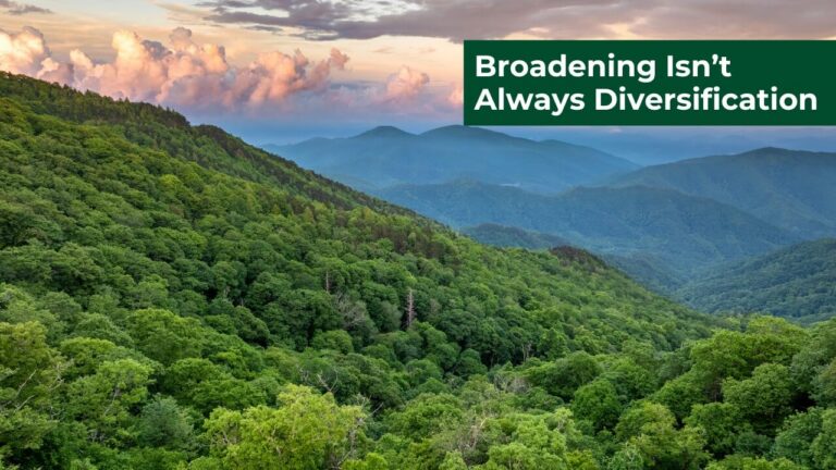 Lush green mountains under colorful sky